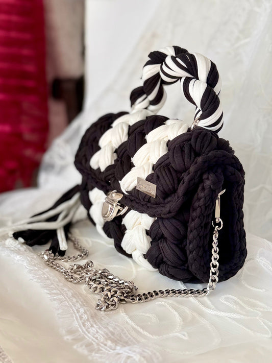 Black and white handwoven mini bag with silver chain strap