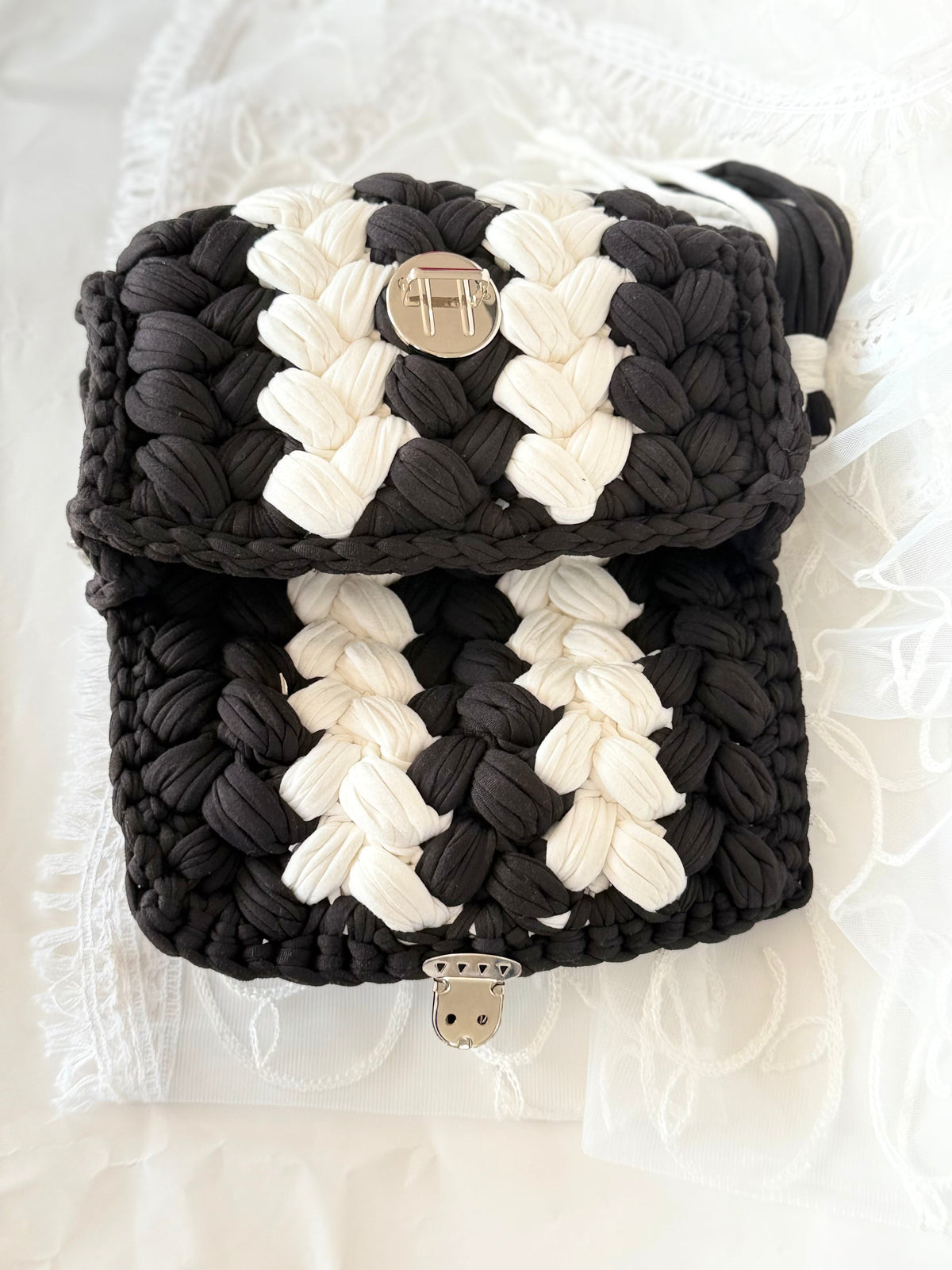 Black and white handwoven mini bag with silver chain strap