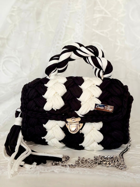 Black and white handwoven mini bag with silver chain strap