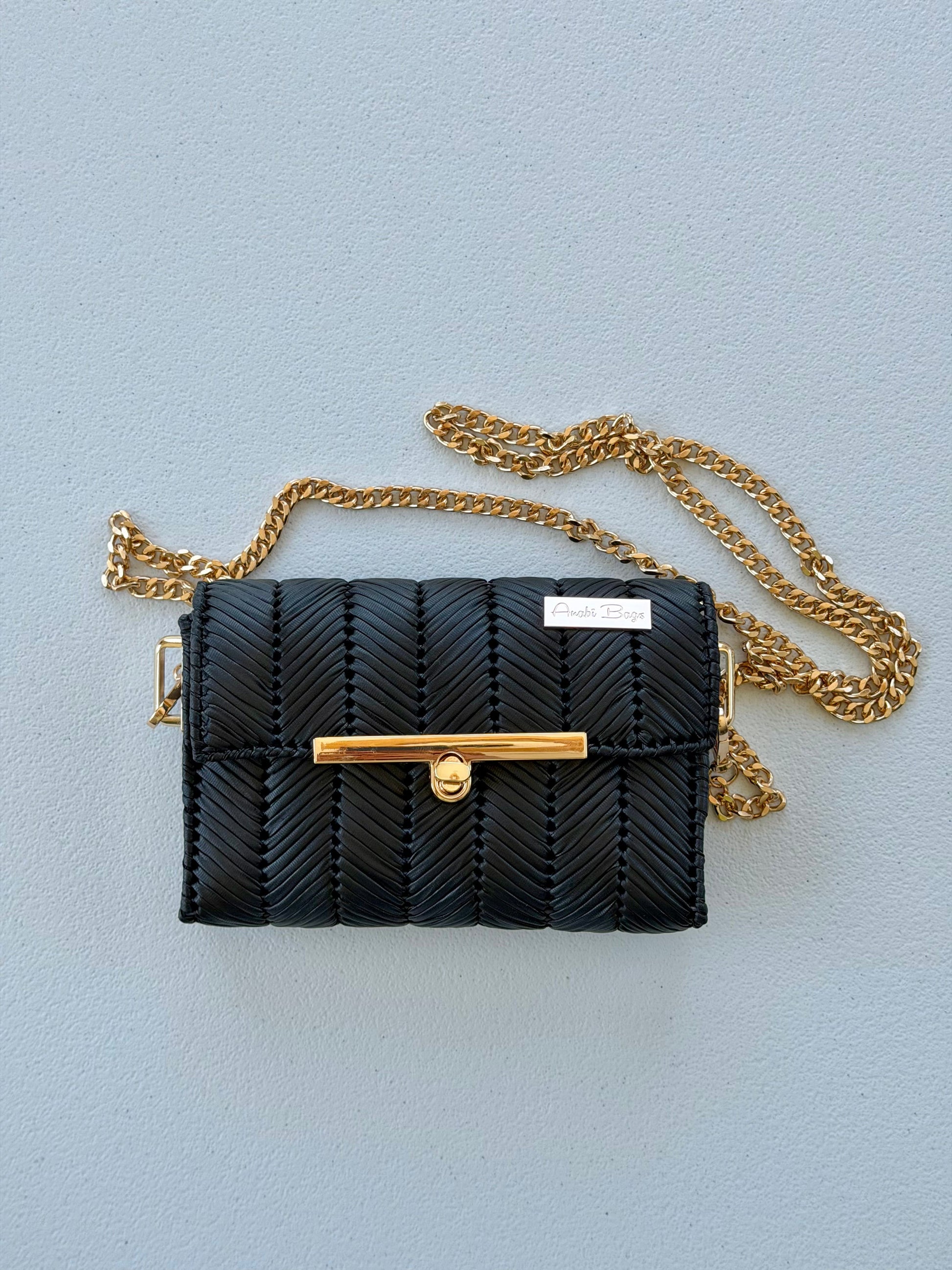 Black handwoven mini clutch with gold chain strap