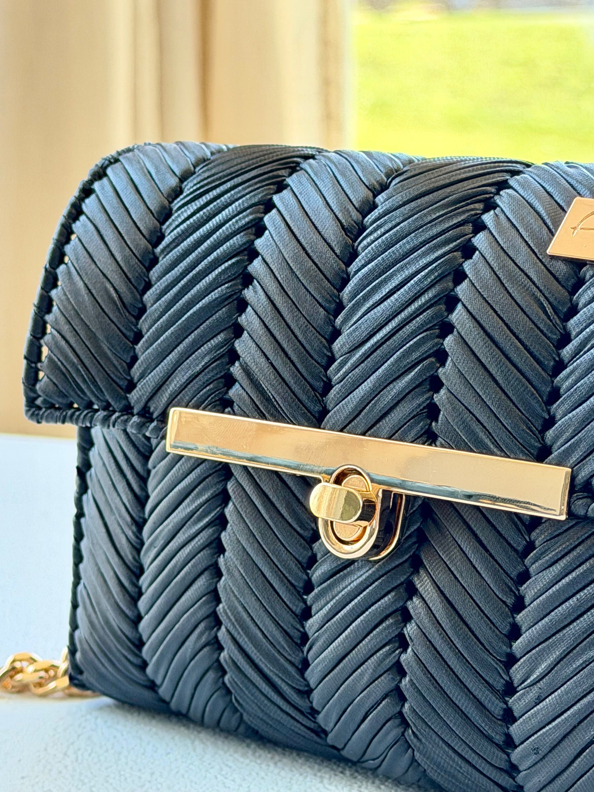 Black handwoven mini clutch with gold chain strap
