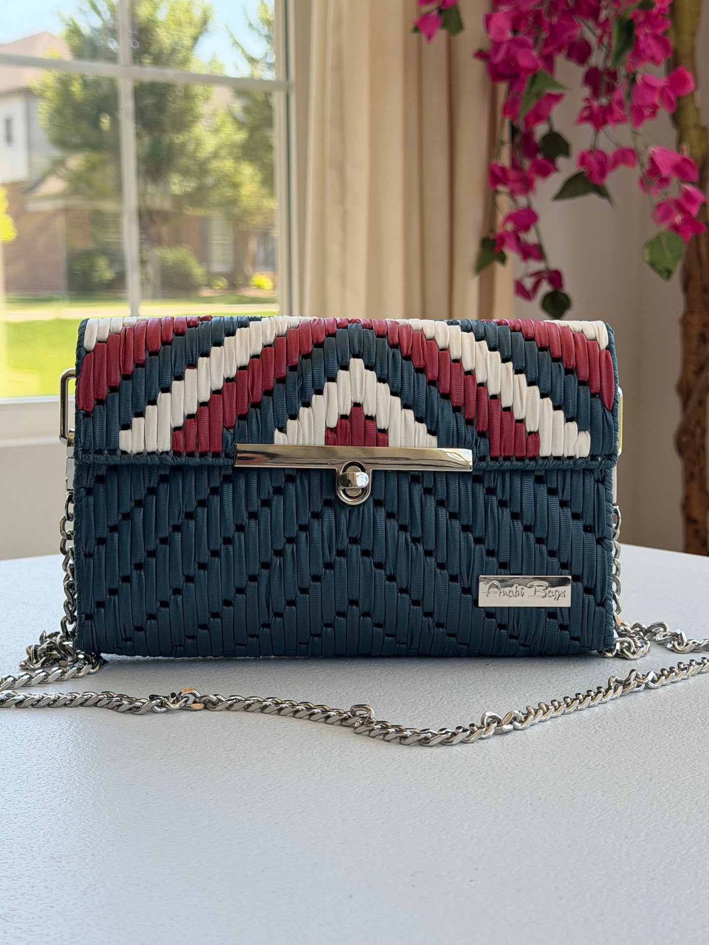 Handwoven crossbody bag with silver chain strap