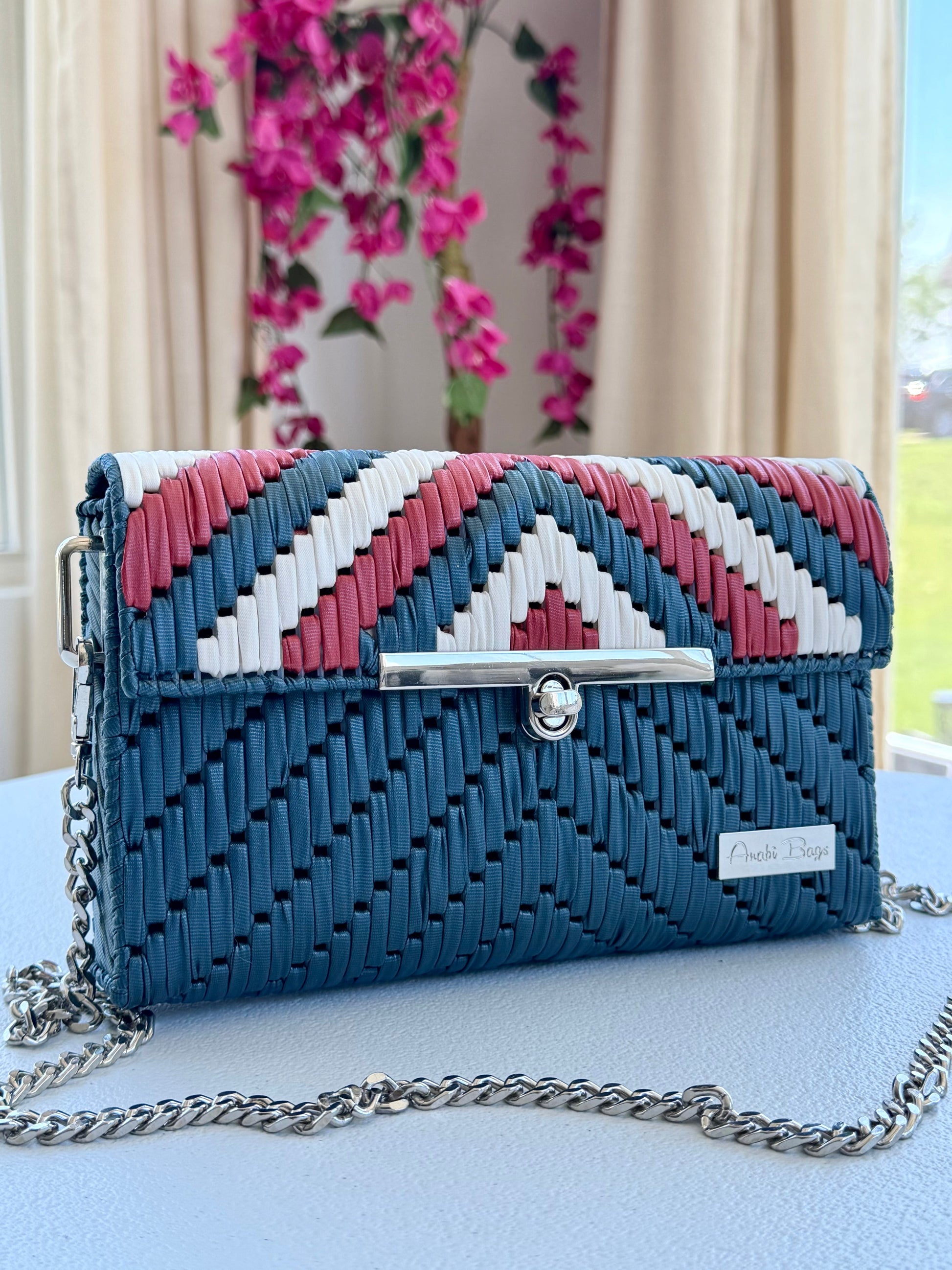 Handwoven crossbody bag with silver chain strap